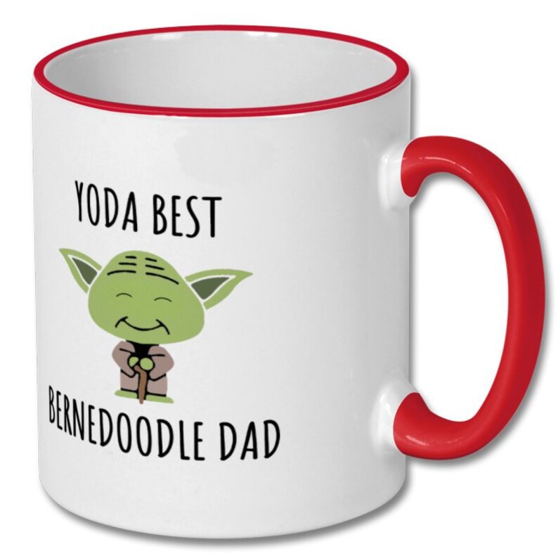 May include: White ceramic mug with a red rim and handle. The mug features a cartoon image of Yoda with the text "Yoda Best Bernedoodle Dad".