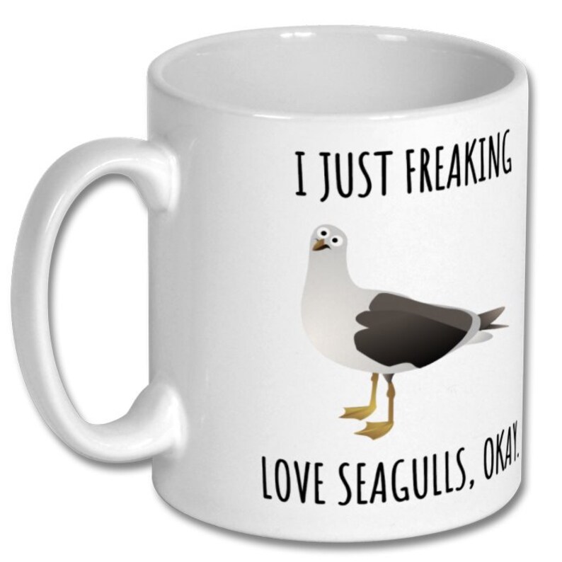 May include: White ceramic coffee mug with a black and white illustration of a seagull and the text "I just freaking love seagulls, okay!"