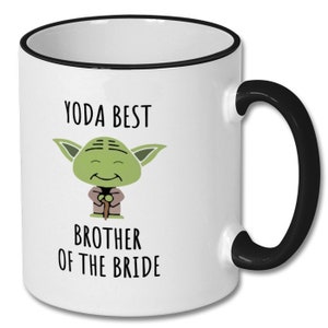 May include: White ceramic mug with a black rim and handle. The mug features a cartoon image of Yoda from Star Wars with the text "Yoda Best Brother of the Bride".