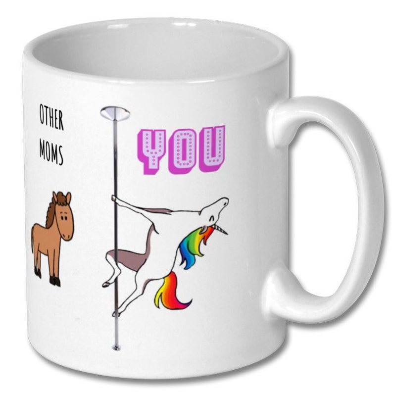 May include: White ceramic coffee mug with a pink unicorn holding a pole and the text "OTHER MOMS" and "YOU" on the mug.