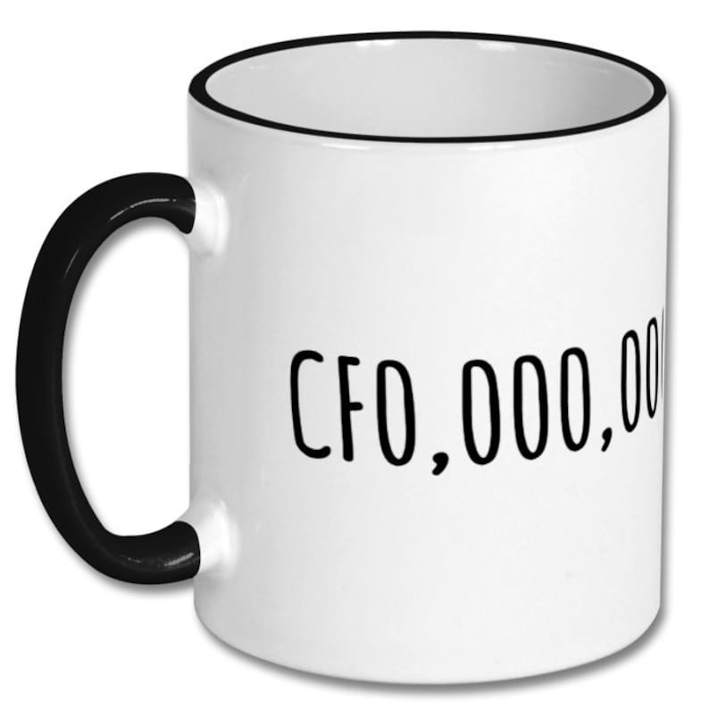 May include: White ceramic coffee mug with a black handle and black rim. The mug has the text "CFO,000,000" printed on the front.