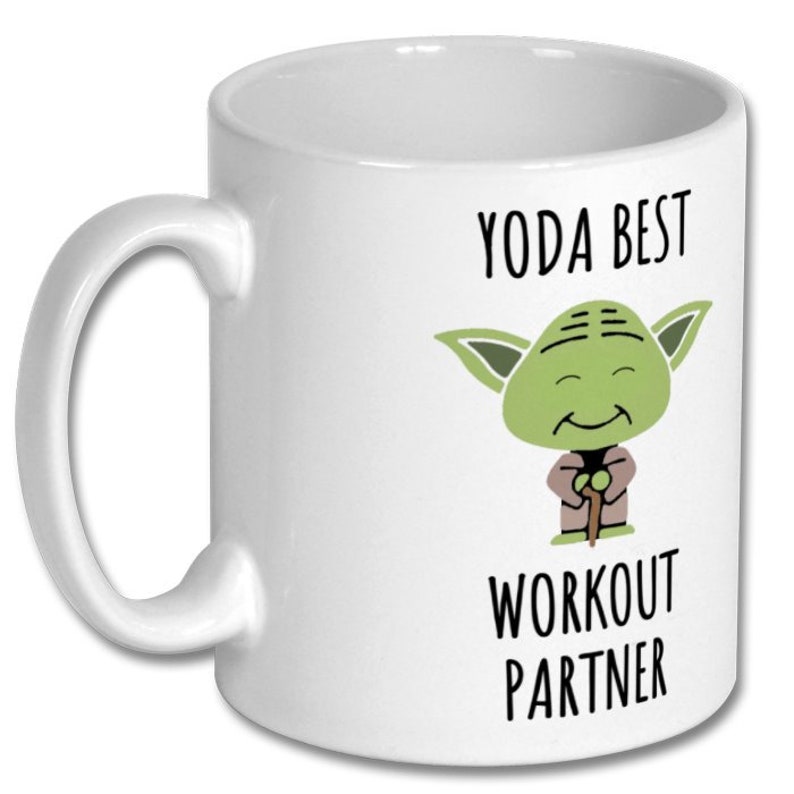 May include: White ceramic mug with a green Yoda character illustration and the text "Yoda Best Workout Partner".