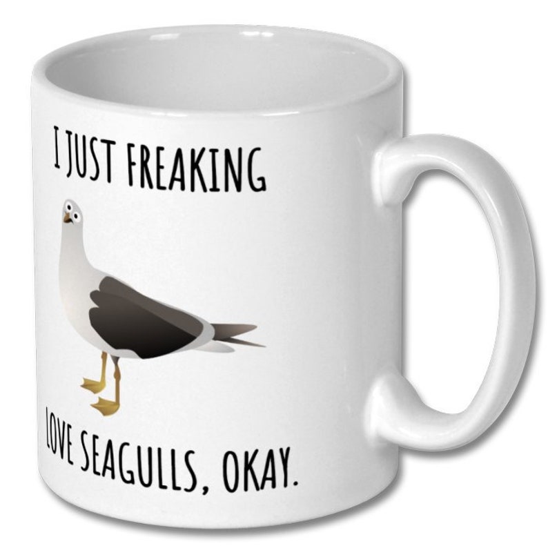 May include: White ceramic coffee mug with a black graphic of a seagull and the text "I just freaking love seagulls, okay."