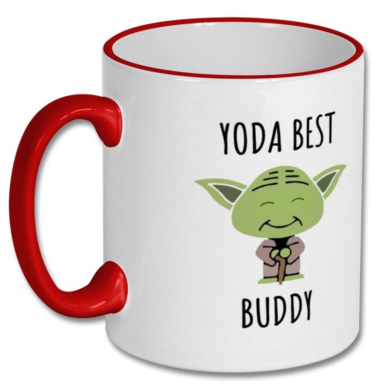 May include: White ceramic mug with a red rim and handle. The mug features a cartoon image of Yoda from Star Wars with the text "Yoda Best Buddy".