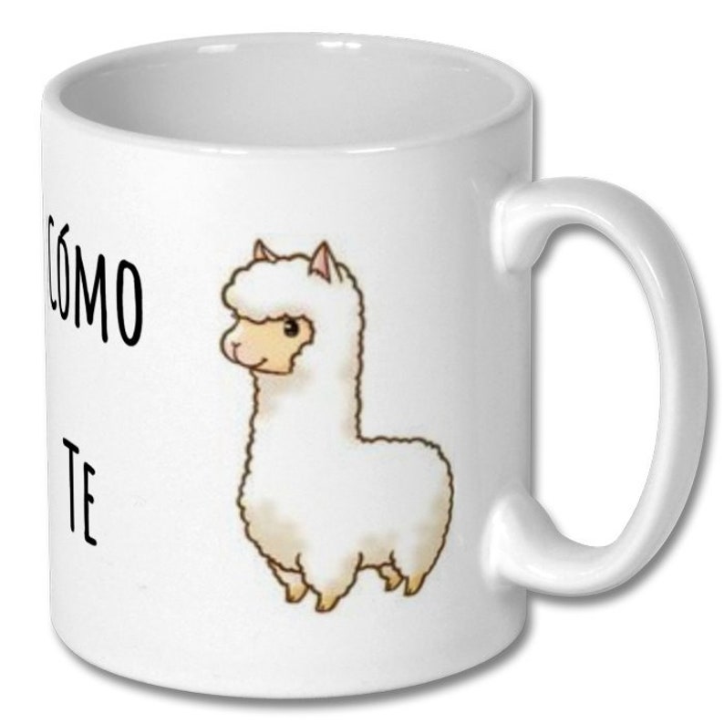 May include: White ceramic coffee mug with a black and white illustration of a llama and the text "COMO TE" printed on the front.