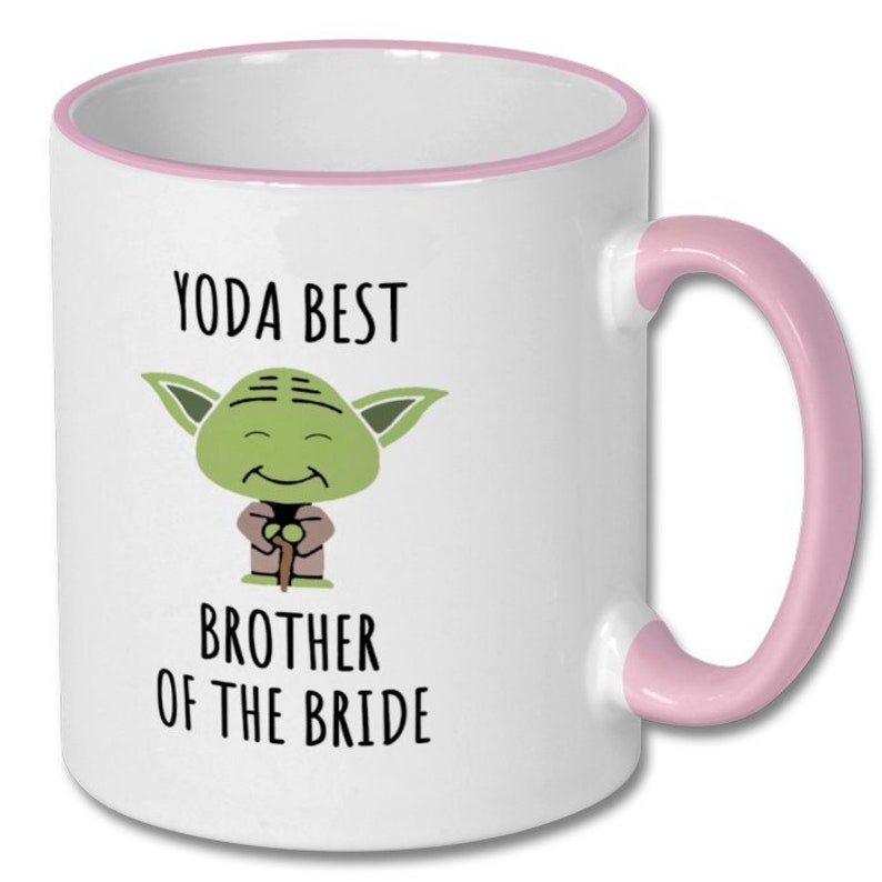 May include: White ceramic mug with a pink rim and handle. The mug features a cartoon image of Yoda from Star Wars with the text "Yoda Best Brother of the Bride".