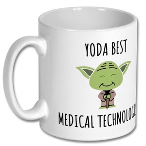 May include: White ceramic mug featuring a green Yoda character and the text "Yoda Best Medical Technologist".