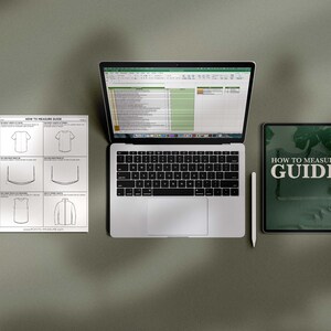 May include: A white sheet of paper with a "How to Measure Guide" for clothing. The guide includes illustrations of a t-shirt, a tank top, and a long-sleeve shirt. A laptop computer with a spreadsheet open and a tablet with a green background and the text "How to Measure Guide" are also visible.