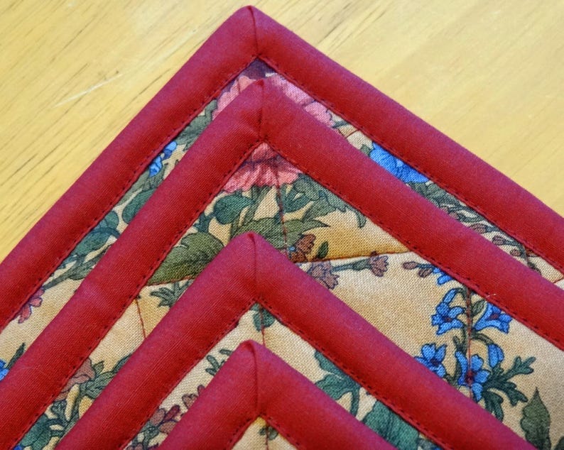 Burgundy and Floral Print Pot Holders with Double Batting Insul Bright and finished off with a Fan Quilting. Loops