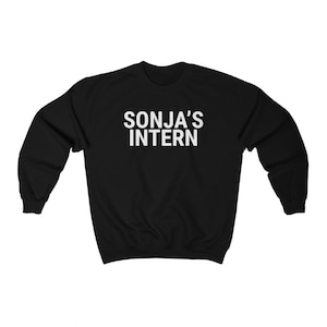 May include: Black sweatshirt with white text that reads "SONJA'S INTERN"