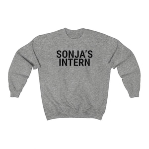 May include: A heather grey sweatshirt with the text "SONJA'S INTERN" printed in black.