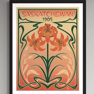 May include: Art Nouveau poster in a black frame. The poster reads "SASKATCHEWAN" and "1905". It depicts orange lilies with green stems and leaves, set against a peach and cream gradient background, evoking a vintage aesthetic.