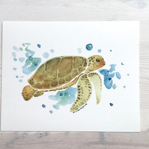 May include: Watercolour painting of a sea turtle swimming in blue and green water. The turtle is brown with a green shell and is surrounded by blue and green watercolour splotches.