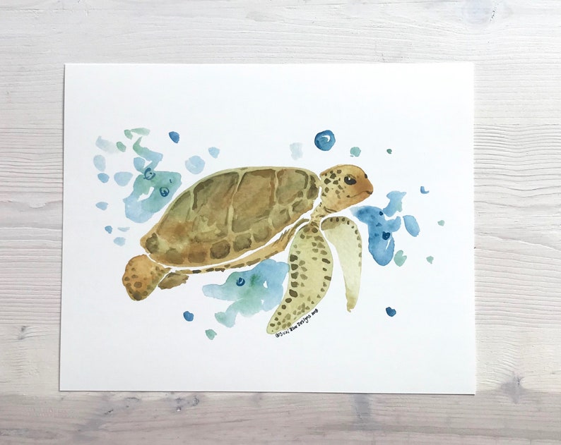 May include: Watercolour painting of a sea turtle swimming in blue and green water. The turtle is brown with a green shell and is surrounded by blue and green watercolour splotches.