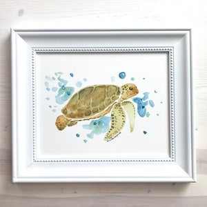 May include: A watercolour painting of a sea turtle swimming in blue and green water. The turtle is brown with a yellow underside and has a white signature in the bottom right corner.