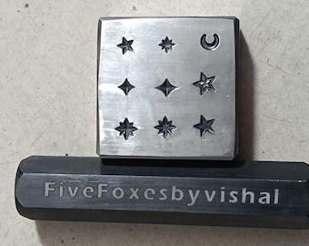 May include: A metal stamp with a variety of star and crescent moon designs. The stamp is labeled "FiveFoxesbyvishal".