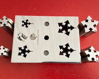 May include: A set of six metal punch tools with a star-shaped design. The tools are arranged on a metal plate with the text "FiveFoxesbyVishal".