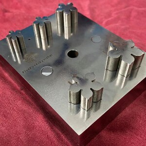 May include: A metal punch with five star-shaped cutouts. The punch is labeled "Five Star Designs".