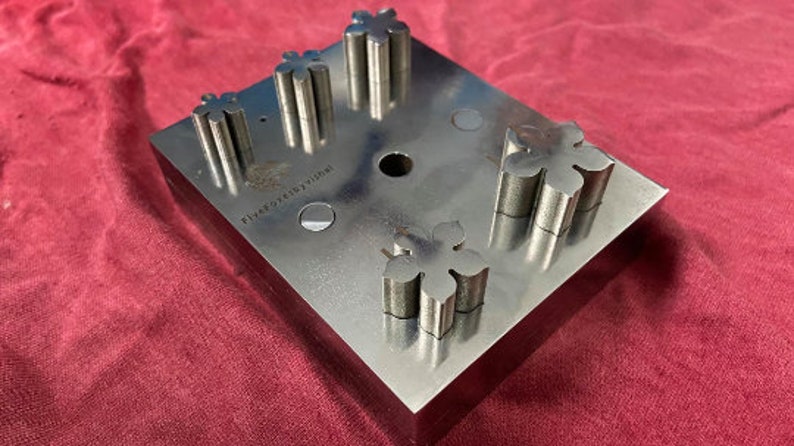 May include: A metal punch with five star-shaped cutouts. The punch is labeled "Five Star Designs".