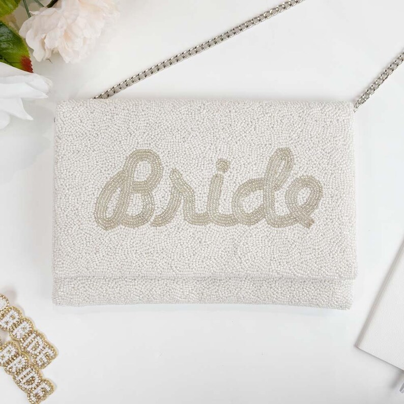 a white purse sitting on top of a white table