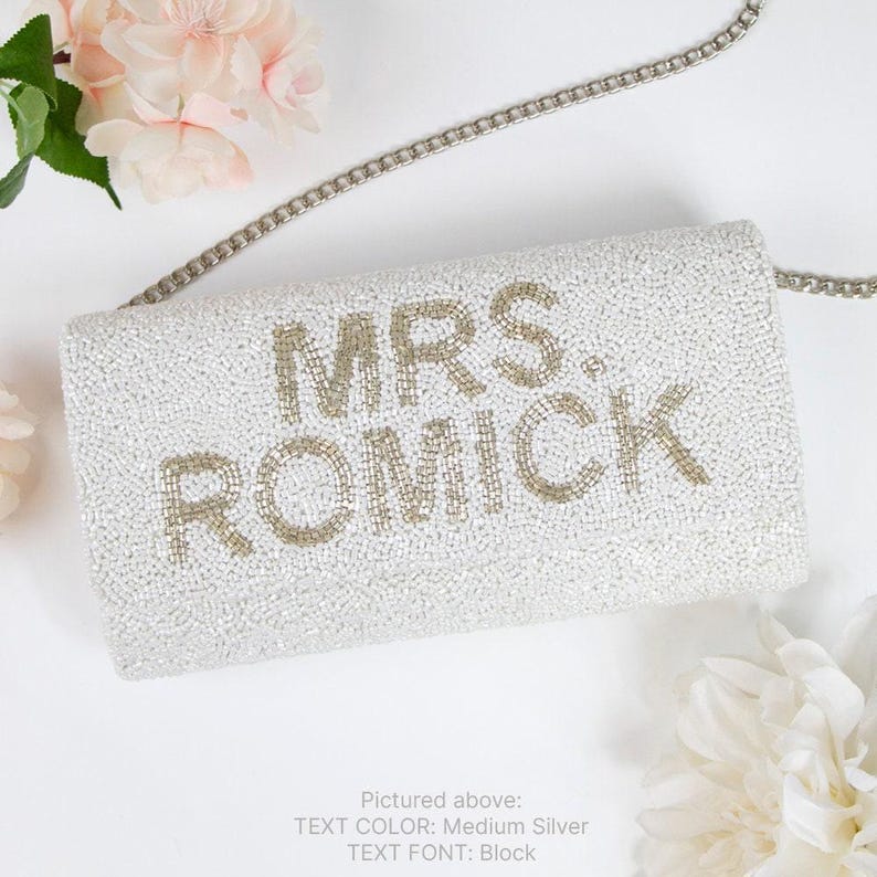 a white purse with the words mrs romick on it