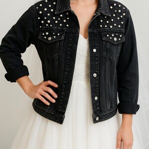 a woman wearing a wedding dress and a denim jacket