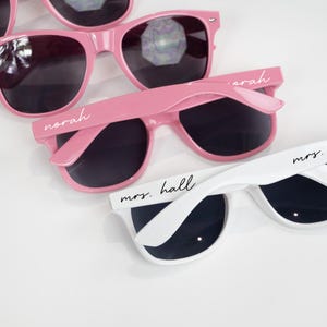 a pair of pink sunglasses sitting next to each other