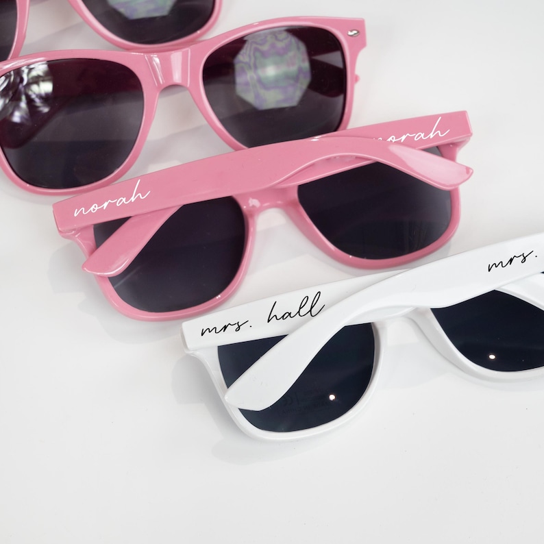 a pair of pink sunglasses sitting next to each other