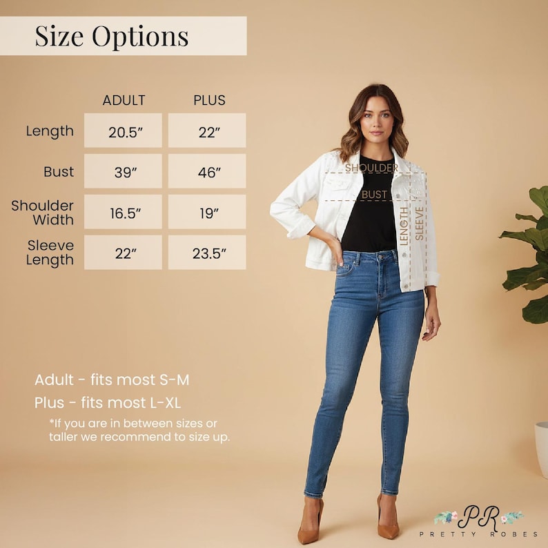 a woman wearing a white jacket and blue jeans, standing in front of a size chart.