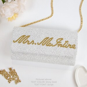a white purse with gold lettering on it