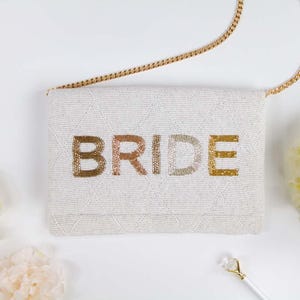 a white purse with the word bride written on it