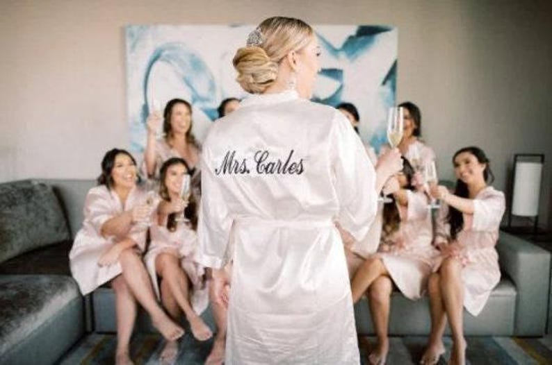 a woman in a robe standing in front of a group of women