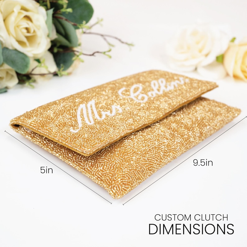 A gold clutch purse with the name "Mrs. Bollins" printed on it, along with measurements indicating it is 5 inches in length and 9.5 inches in width.