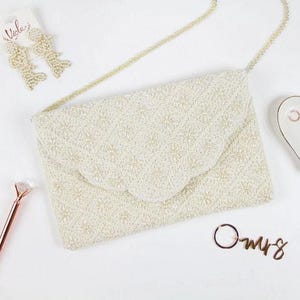 a white purse sitting on top of a white table