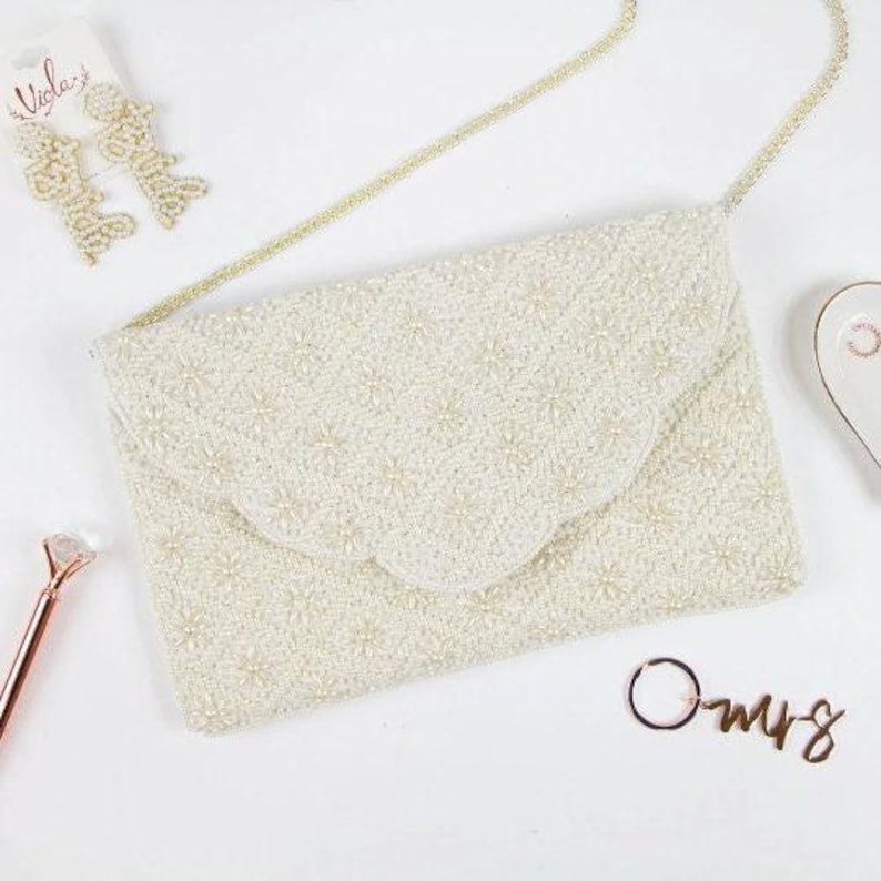 a white purse sitting on top of a white table