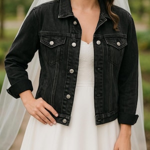a woman in a white dress and a black jacket