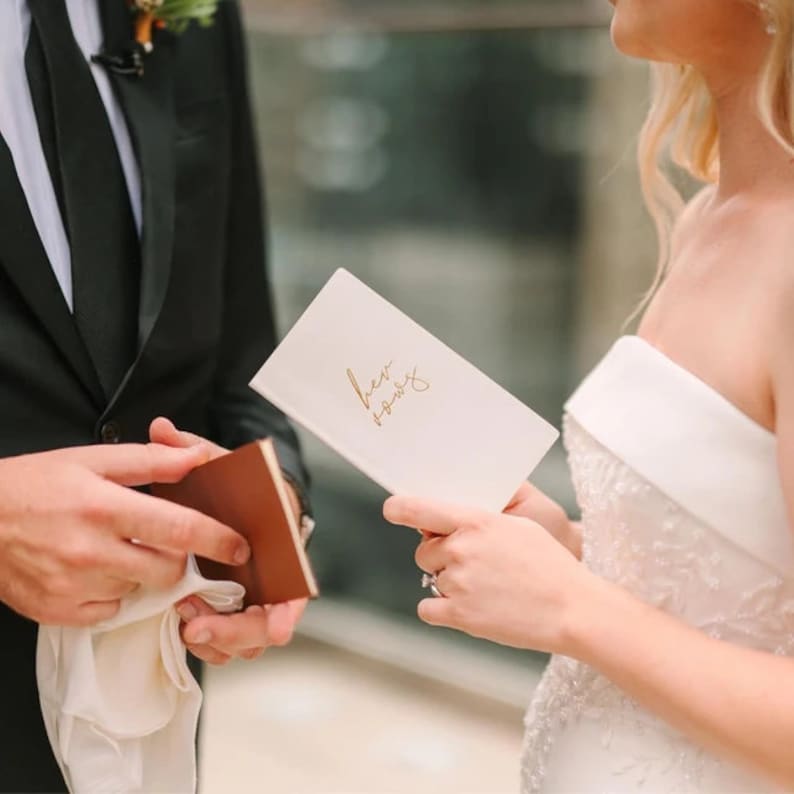 a man and a woman holding a card and a box