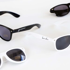three pairs of sunglasses sitting on top of a table
