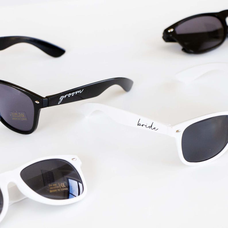 three pairs of sunglasses sitting on top of a table