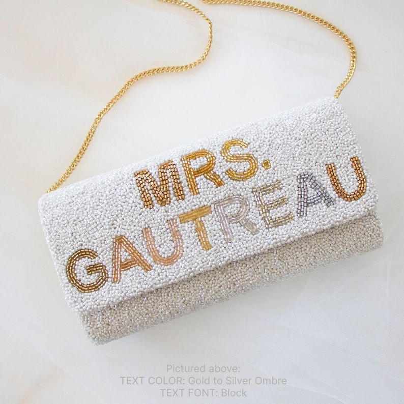 a white purse with gold lettering on it