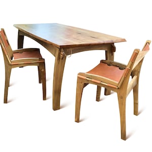 May include: A wooden dining table set with two chairs. The table has a natural wood finish and the chairs have leather seats.