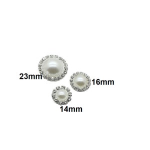 May include: Three pearl and rhinestone embellishments in different sizes: 23mm, 16mm, and 14mm. The embellishments are white with silver rhinestones.