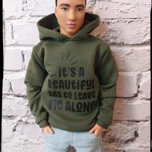 Male and female fashion doll clothes. Olive green hoodie with black wording. Fits male and female  12&quot; dolls. Made on order.