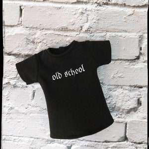 May include: A black t-shirt with a white "old school" graphic printed on the front.