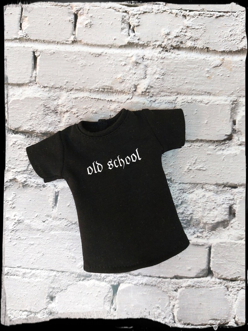 May include: A black t-shirt with a white "old school" graphic printed on the front.