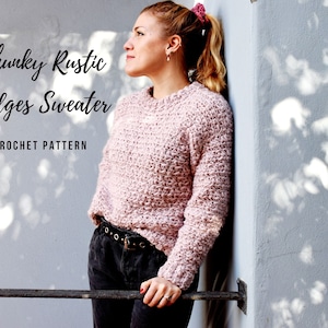 May include: A pink chunky knit sweater with a ribbed texture. The sweater is crocheted and has a relaxed fit. The text "Chunky Rustic Ridges Sweater CROCHET PATTERN" is displayed on the image.