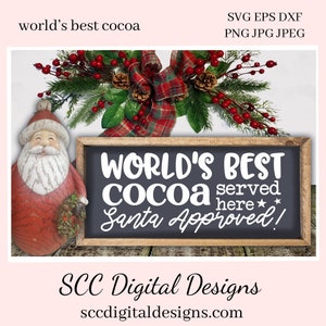 May include: A black chalkboard sign with white text that reads "WORLD'S BEST COCOA served here* Santa Approved!"  A small Santa figurine is on the left side of the sign.  The sign is decorated with a red and black plaid bow and a green garland with red berries.