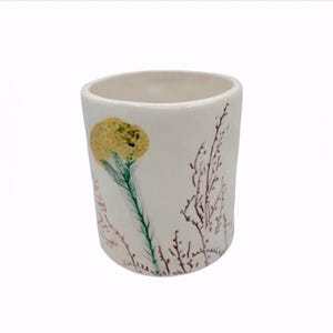 Pu&ograve; includere: Un set di tre tazze in ceramica con finitura opaca e macchiettata. Le tazze sono nei toni del crema, grigio chiaro e grigio scuro. Ogni tazza ha un design semplice e minimalista e un manico arrotondato.