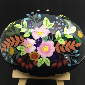 Colorful boho flowers an foliage on a black background hand painted rock sealed in resin unique gift idea