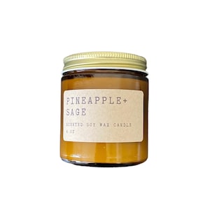 May include: A brown glass candle jar with a gold lid. The label reads "Pineapple + Sage" and "Scented Soy Wax Candle 4 oz".